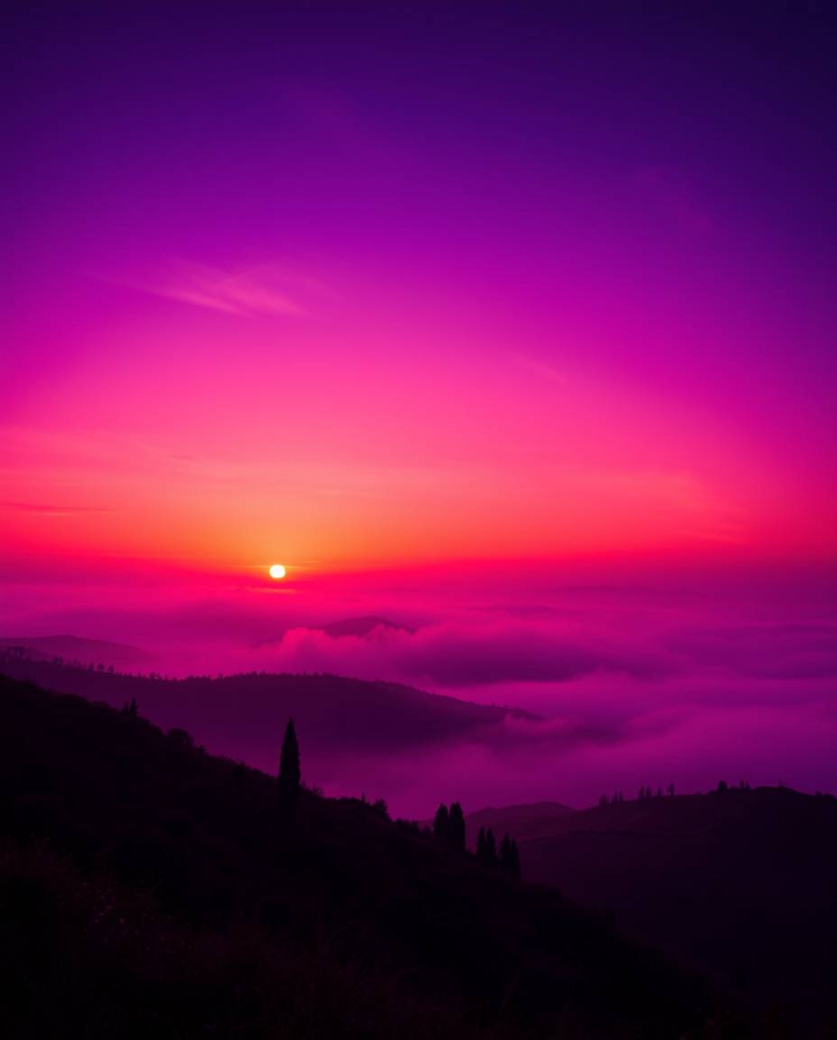 Deep ultraviolet hues, low-angle perspective: Dramatic sunset over misty Tuscan hills, vivid purples, high contrast, looking 
