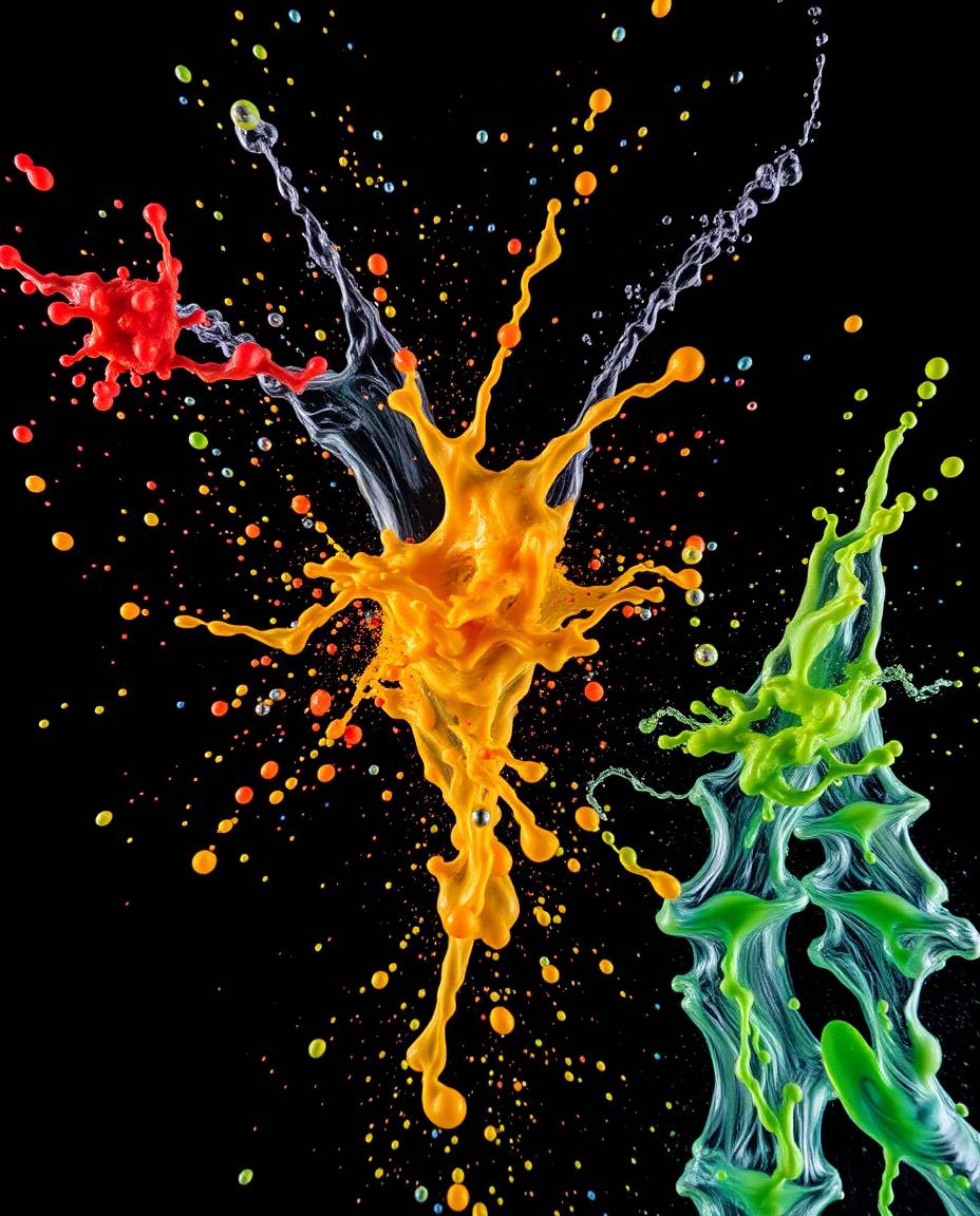This stunning high-angle photograph captures dynamic and colorful splashes frozen in time against a stark black background. T
