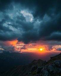 Witness a dramatic cinematic style sunset from a high alpine peak, featuring a film-like composition and lighting. The scene 