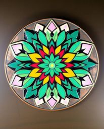This artwork showcases a stunning geometric floral mandala with a vibrant, symmetric design, meticulously displayed on a cast