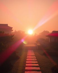 Precise architectural color photography in classic black and white depicting a sunset over a serene Zen garden with timeless 