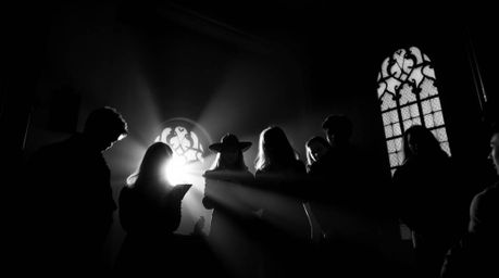 Experience the timeless elegance of a classic black and white silhouette photograph depicting teenagers unraveling mysteries 