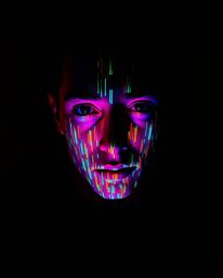 A captivating high-angle photograph showcases a vibrant digital glitch transforming a human face into a mesmerizing data stre