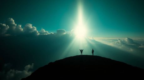 A high-angle photograph featuring a rich, deep teal color palette and silhouetted backlighting. Steps of light ascend into a 