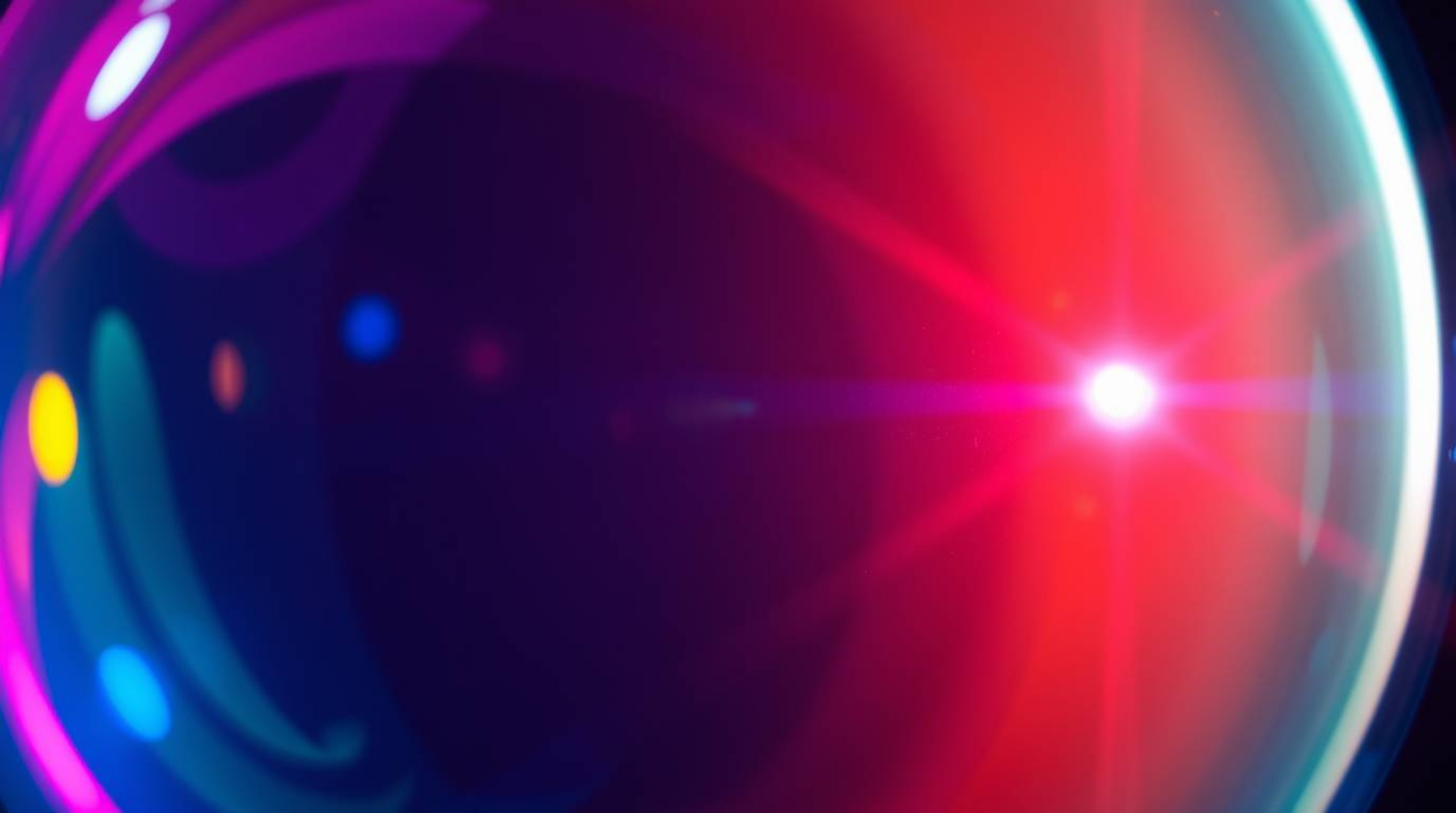 A captivating close-up image showcasing a glass object's surface reflecting smooth, electric vivid gradient textures with bri