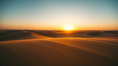Experience the breathtaking beauty of a desert sunset in extreme macro detail. This captivating image showcases golden dunes 