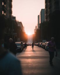 A unique piece styled as a candid street photograph, capturing the spontaneous moment of a sun setting behind a dramatic wate