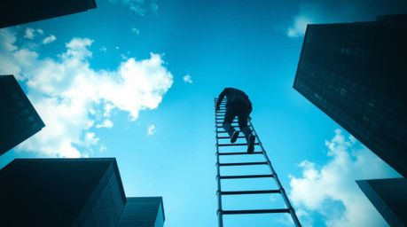 Experience a disturbing and unsettling mood with this image showcasing a businessperson climbing a transparent ladder that va