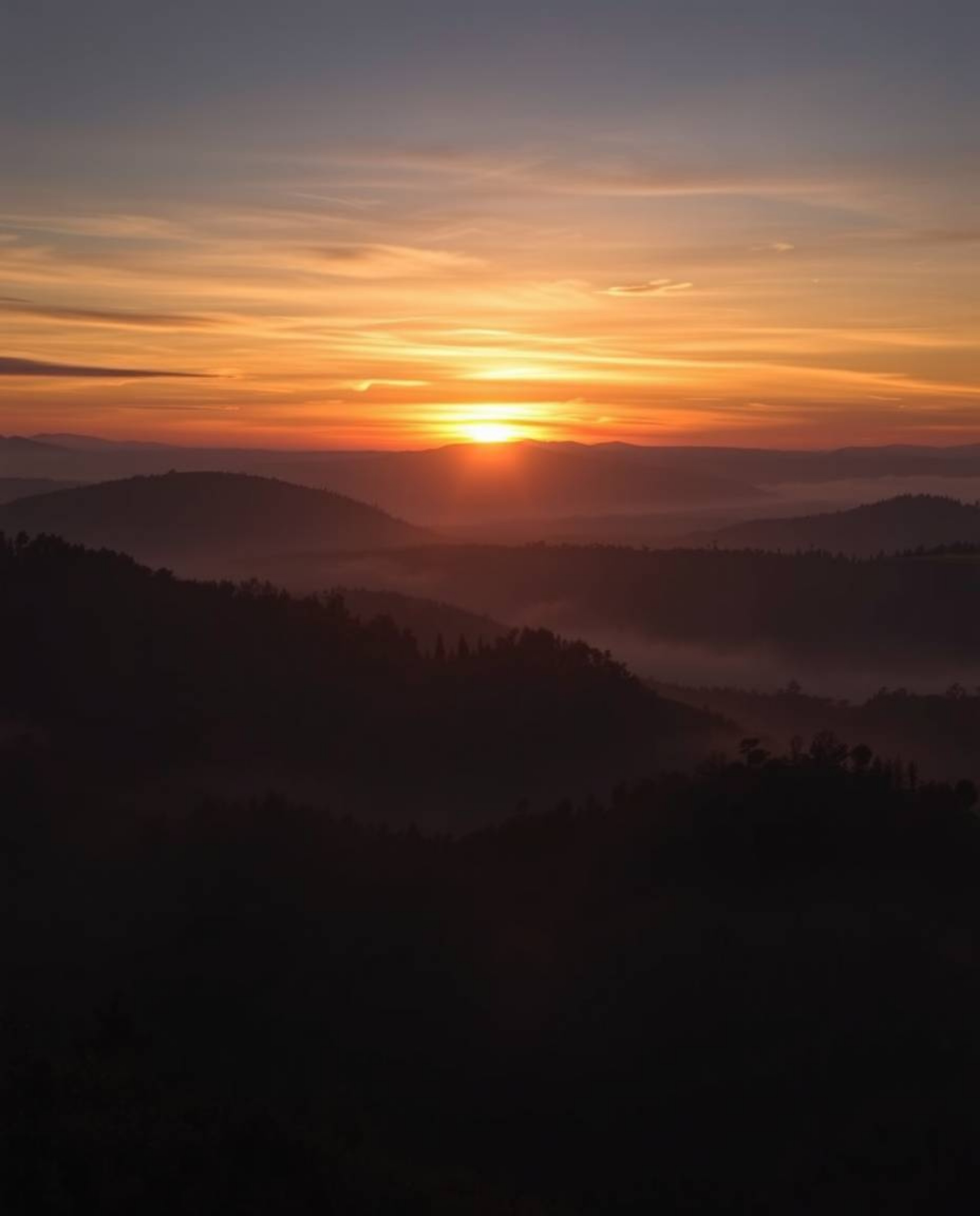 Intense dramatic lighting depicting sunset over misty Tuscan hills, high contrast, creating tension.