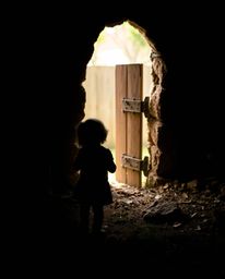 A child stumbles upon a magical portal hidden in their backyard, bathed in the dramatic light and shadow of chiaroscuro. The