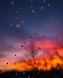 A graceful and elegant scene captures snowflakes falling during a vibrant sunset. The image is defined by its intense dramati