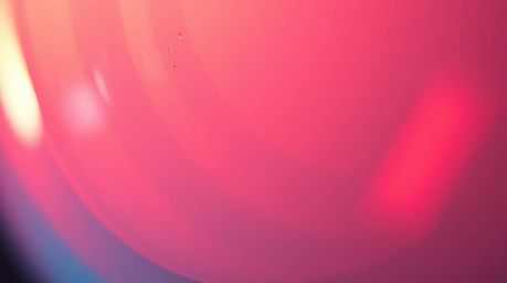 This captivating image showcases a close-up detail of a glass object, masterfully reflecting smooth gradient textures and bat