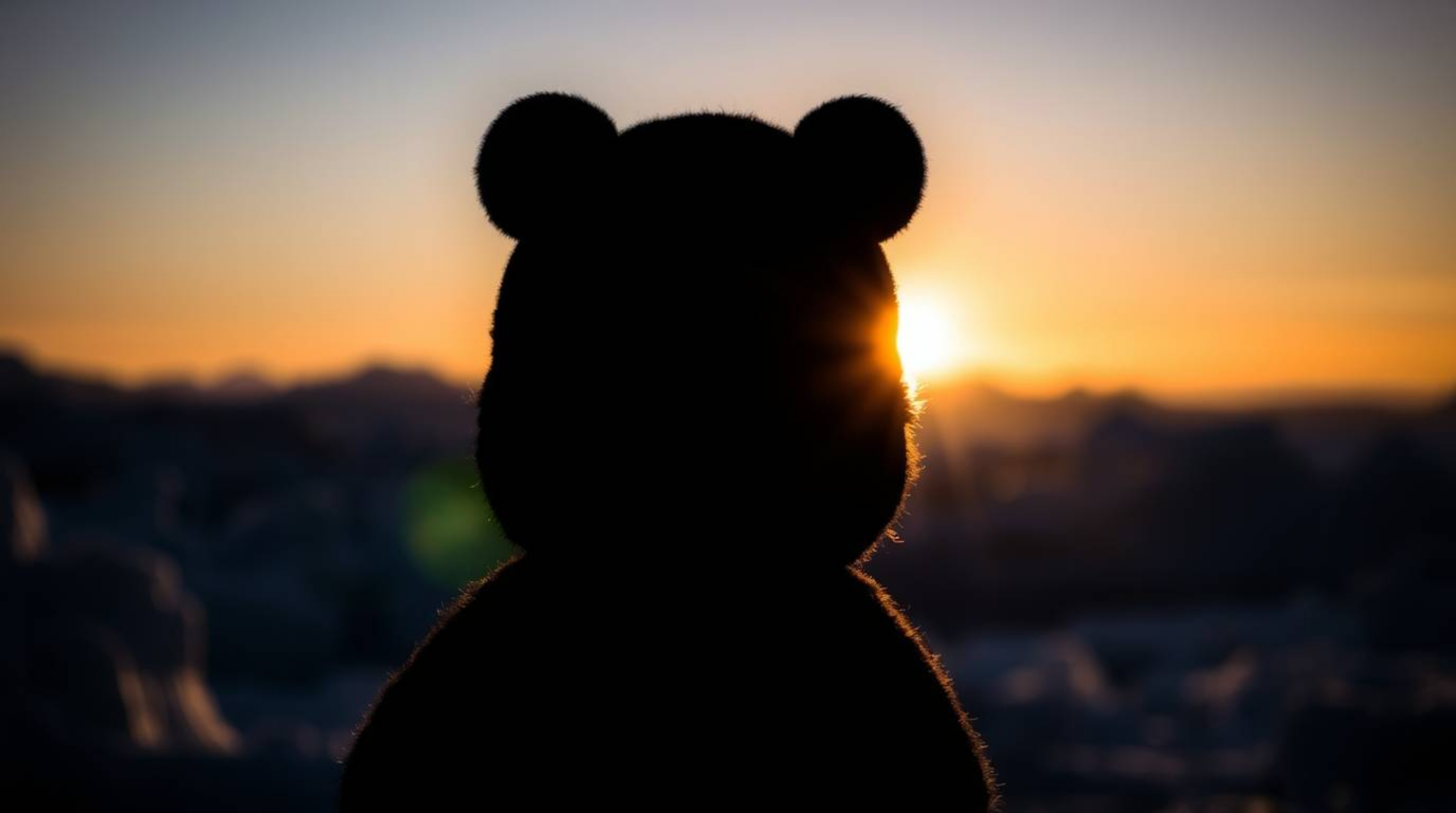A stunning silhouetted backlighting captures a breathtaking sunset over icy polar glaciers, where the light source positioned