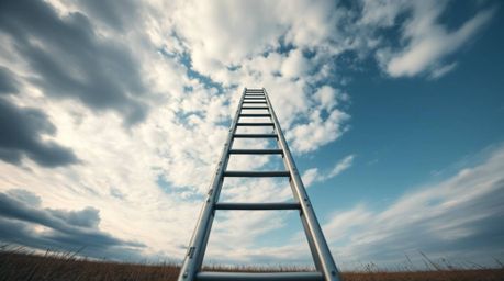 A minimalist scene featuring a silver ladder standing in an open field under a wide cloudy sky creates an abstract metaphor f