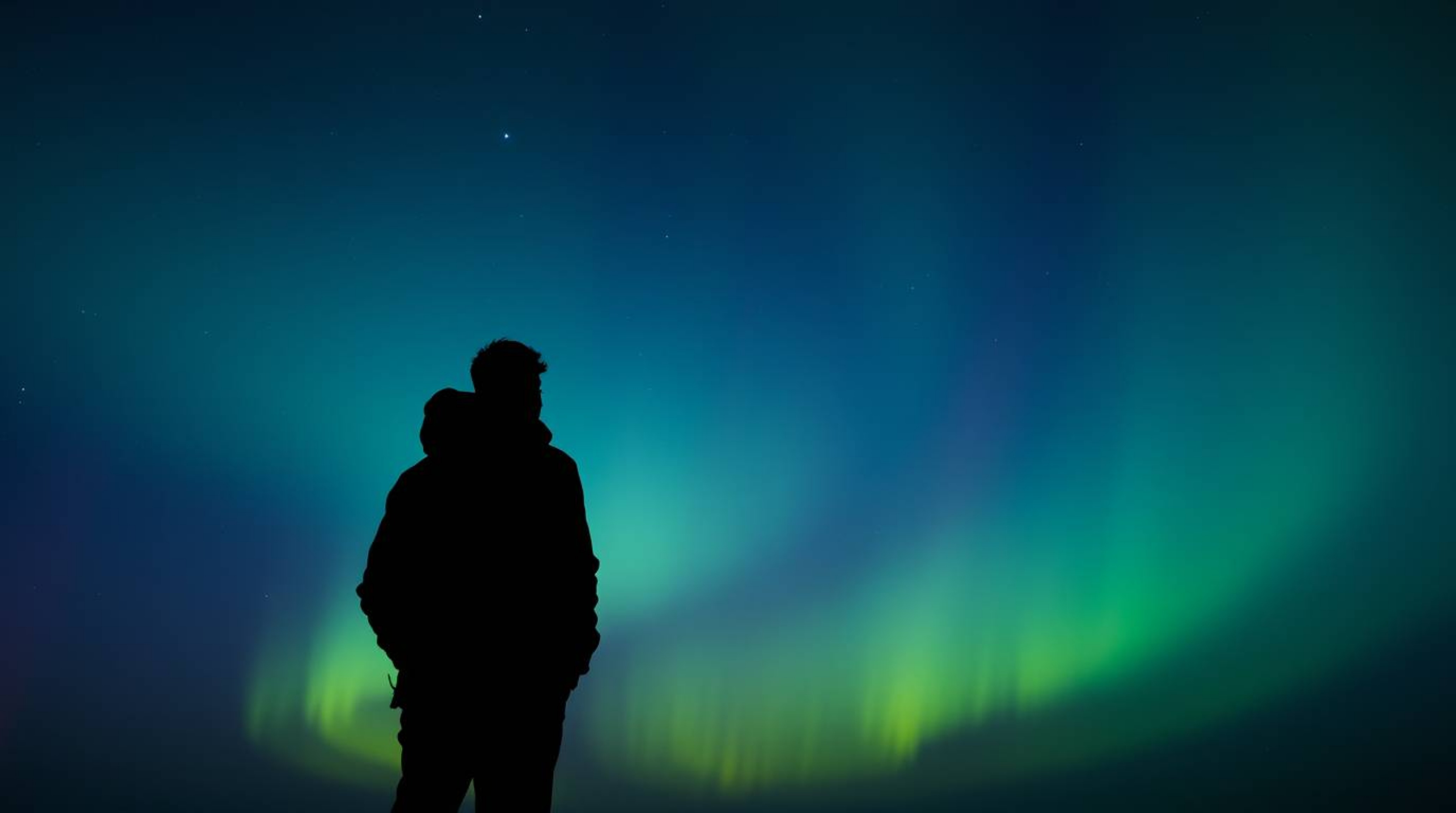 This image features a silhouetted figure captured from a low angle perspective with dramatic backlighting.  The gradient text