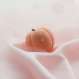 Immerse yourself in a close-up ASMR experience featuring a meticulously sculpted clay peach resting on delicate pastel pink s