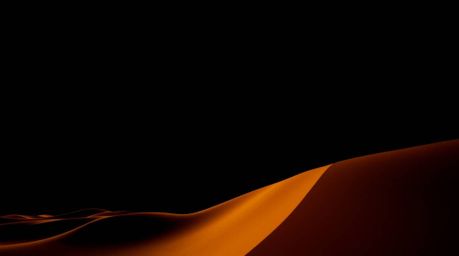 A captivating low-angle shot depicts a jet-black sunset at the edge of a desert, showcasing towering golden dunes against a p