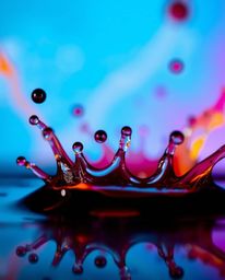 A captivating close-up macro photograph showcasing the intricate details of ink swirling in water.  The image features vibran