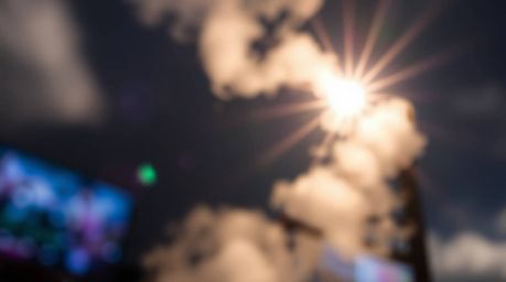 A captivating image depicting a winding stairway composed of smoke and light, sharply in focus against a softly blurred backg