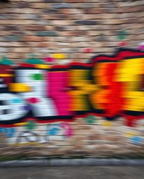 Capture the essence of urban art with this high-resolution stock photo featuring dynamic motion blur and vibrant graffiti spl