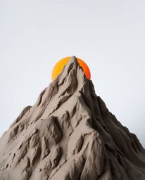 This is a unique artwork capturing a high alpine peak sunset, skillfully sculpted from clay. The piece features intricately m