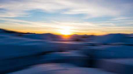 Experience the breathtaking beauty of a dynamic motion blur image capturing a vibrant sunset over icy polar glaciers. The coo
