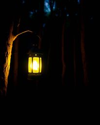 Immerse yourself in a captivating scene featuring a glowing lantern that casts vibrant, complimentary colors throughout a dar