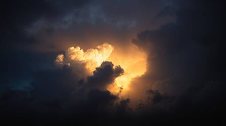Experience the dramatic beauty of chiaroscuro lighting as it paints thunderstorm clouds illuminated by the warm glow of the s