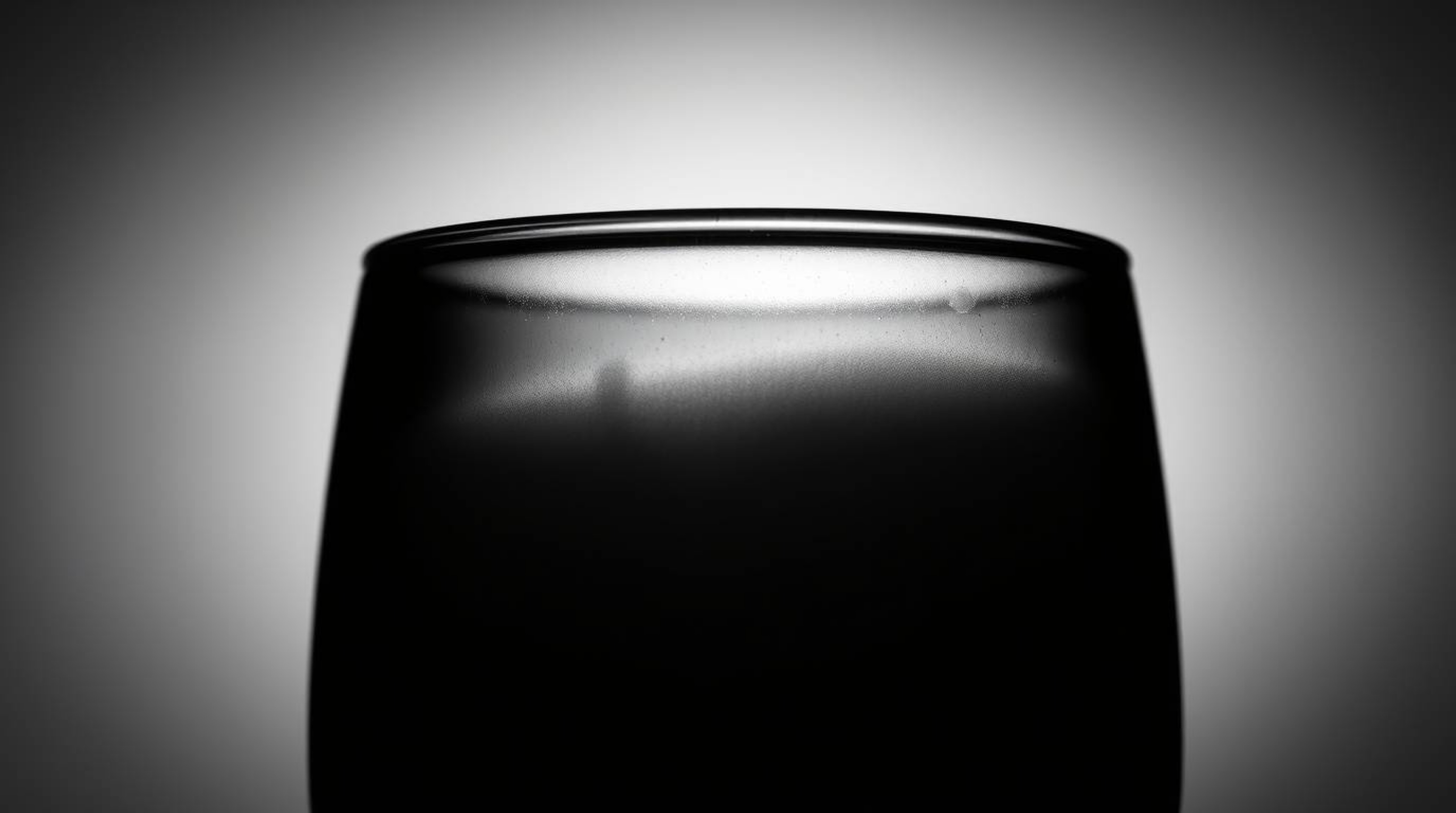 Explore the timeless elegance of silhouetted backlighting with this classic black and white image. A glass object beautifully