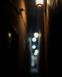 Capture the mystery of the night with this high-resolution stock photo showcasing a pair of elegant eyes peering from the sha