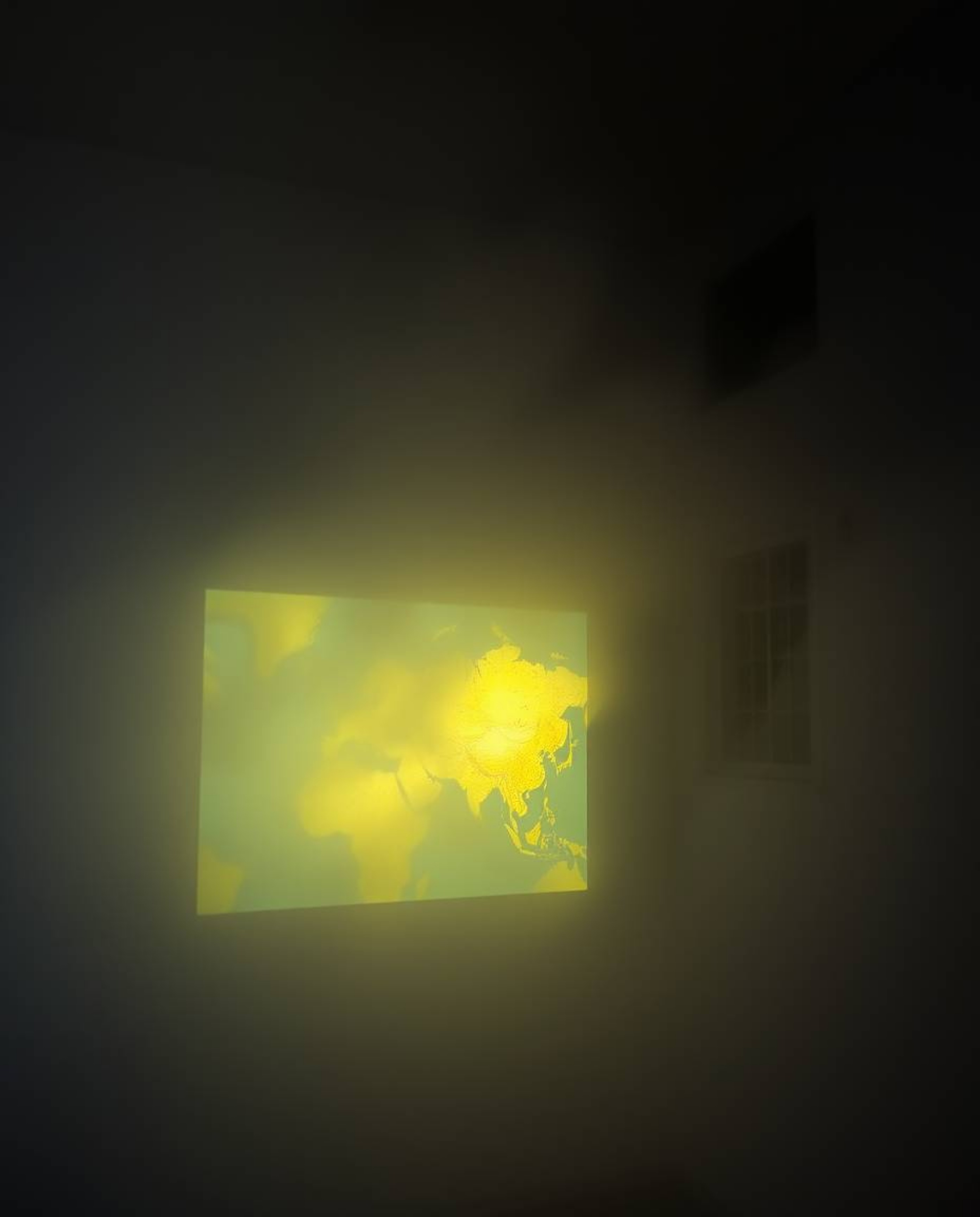 A captivating image depicting a glowing map projected in an old study, shrouded in thick fog.  The low visibility adds to the