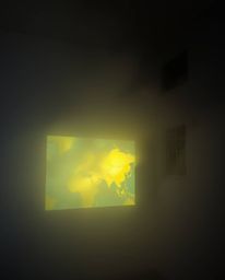 A captivating image depicting a glowing map projected in an old study, shrouded in thick fog.  The low visibility adds to the