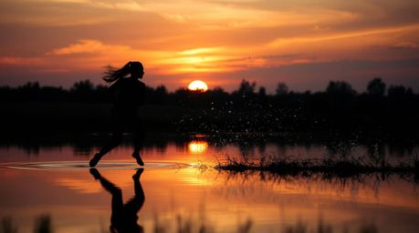 Explore captivating visuals showcasing dynamic motion and intense jet black contrasts, alongside the serene reflection of a c