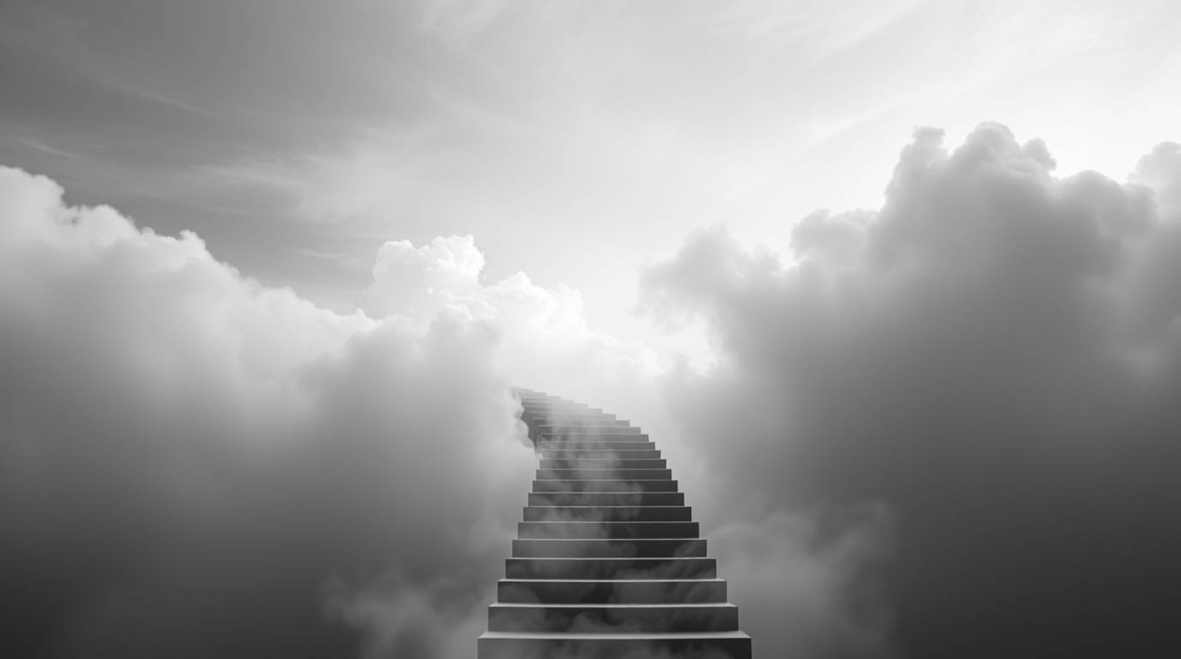 A classic black and white photograph evoking an ethereal and spiritual vibe. A winding stairway of smoke and light ascends in