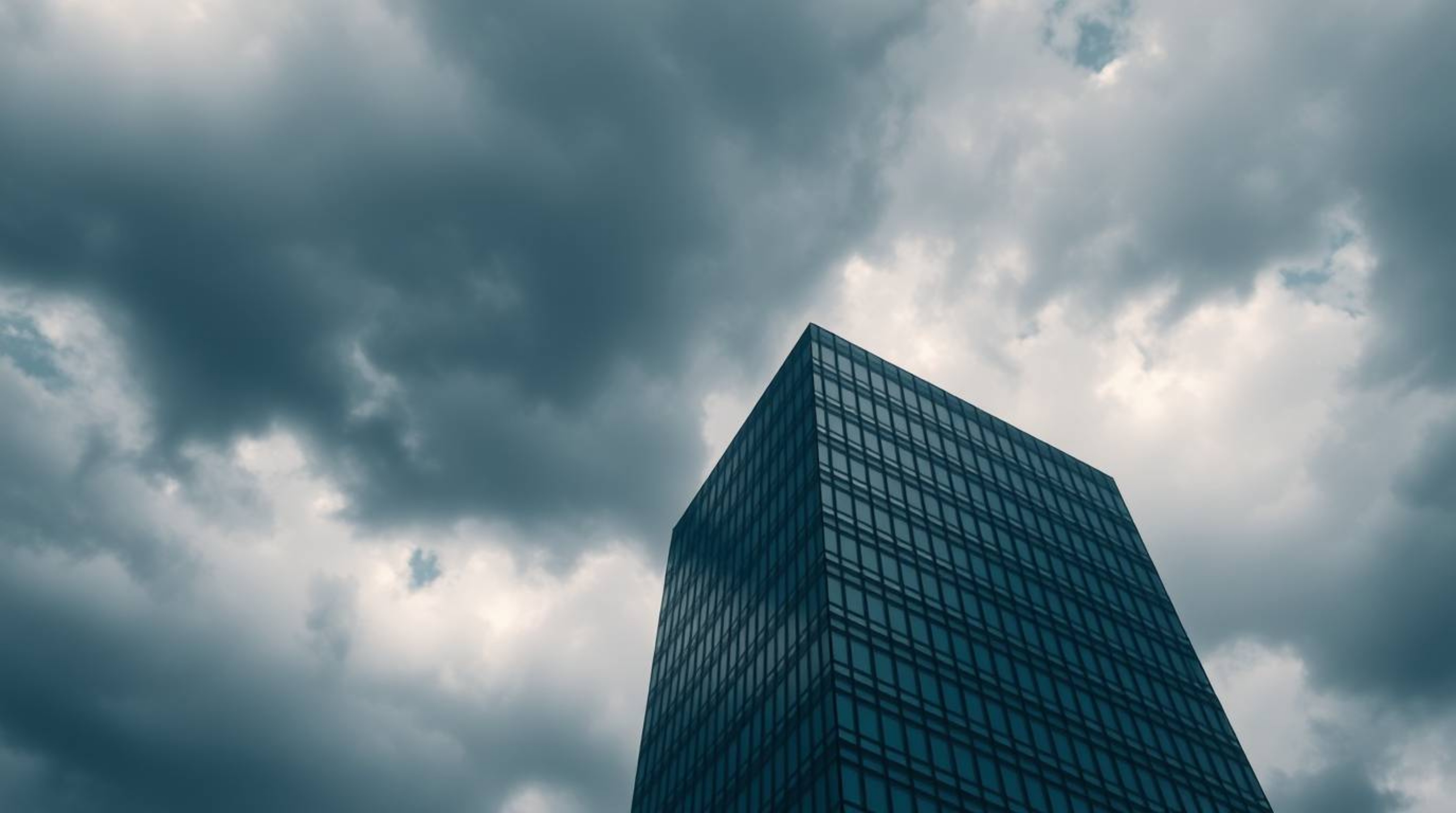 A high-resolution stock photo capturing a modern glass building seemingly dissolving into a dramatic stormy sky with soft clo