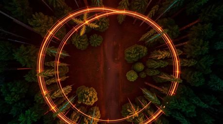 Experience a captivating overhead bird's-eye view of an abstract light art depicting a chase scene through a mesmerizing loop