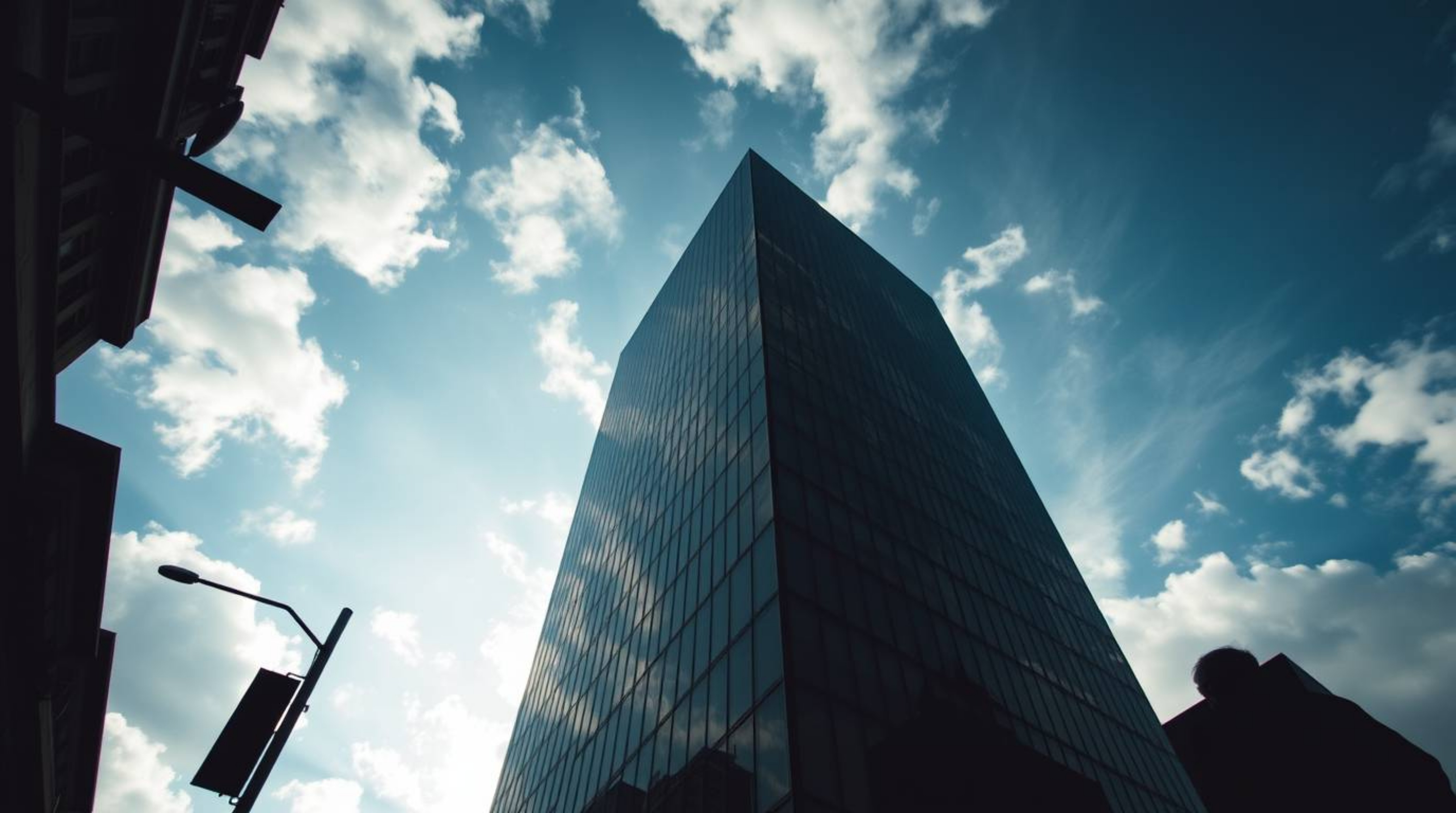 Capture the essence of modern urban life with low angle candid street photography, focusing on a modern glass building seemin