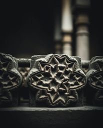 Explore the beauty of Islamic geometric art through a moody, low-contrast image showcasing sharp stone carvings with intricat