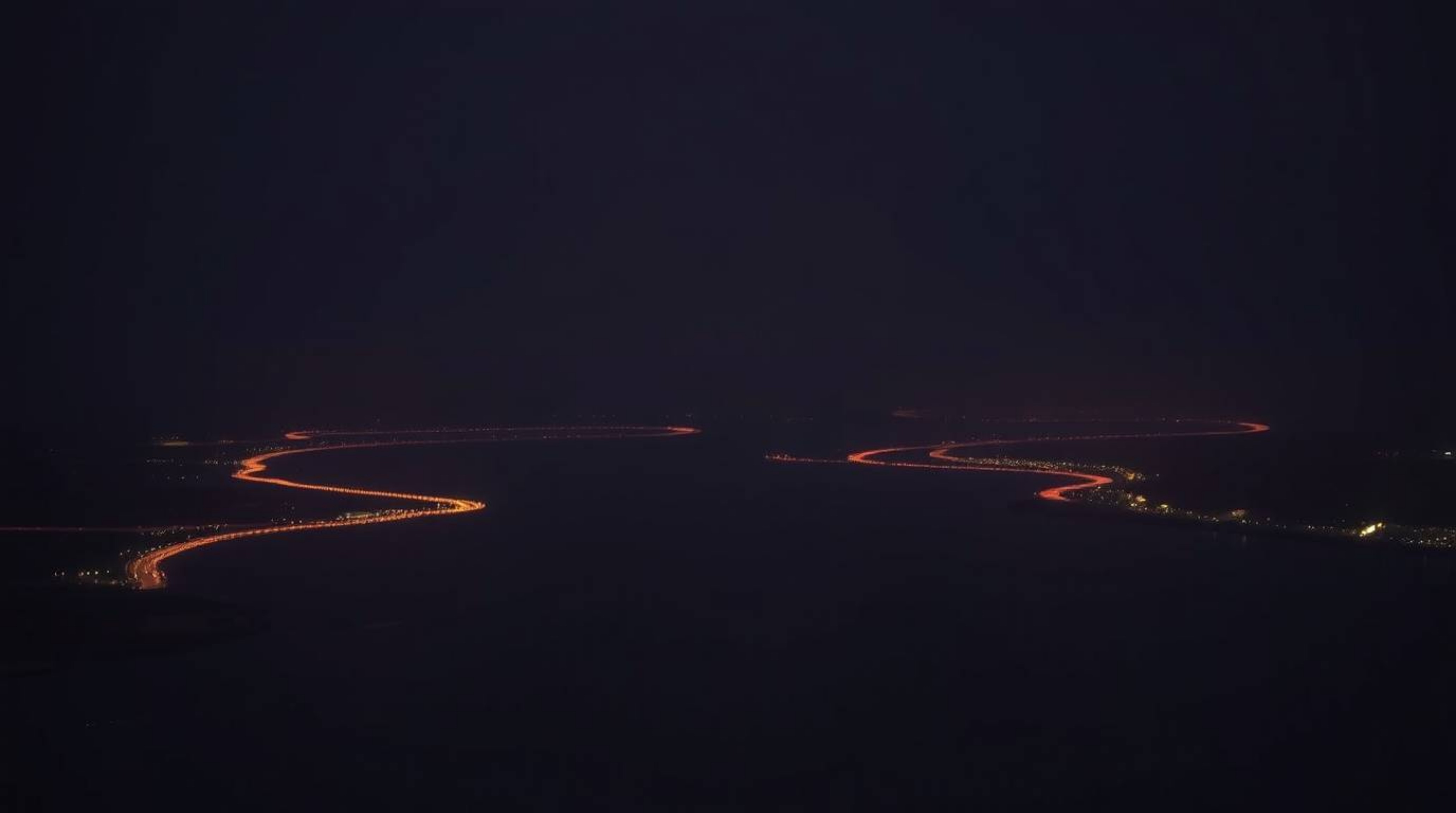 A captivating photograph showcasing a river delta bathed in the warm glow of twilight.  Captured in the style of Associated P