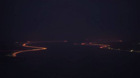 A captivating photograph showcasing a river delta bathed in the warm glow of twilight.  Captured in the style of Associated P