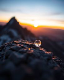 Discover a unique perspective of a sunset from a high alpine peak with this extreme macro close-up shot. Utilizing long expos