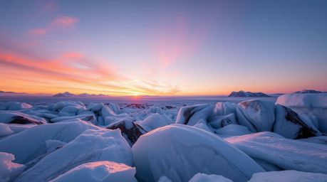 This fine art photograph captures a serene sunset over icy glaciers, characterized by soft pastel colors and styled as profes