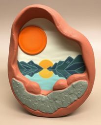 A sculptural clay art piece depicting a sunset reflected in a glassy fjord. This artwork features carefully modeled shapes an