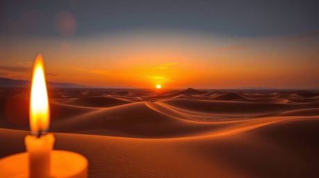 A stunning high-resolution stock photo depicting a breathtaking sunset over majestic golden desert dunes.  The warm, flickeri