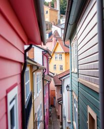 Discover a captivating extreme macro photograph of a tranquil town.  Pastel-colored houses and sharp architectural details ar