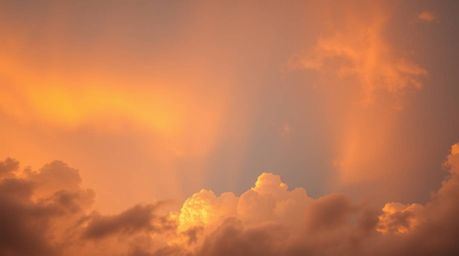 Experience the breathtaking beauty of a thunderstorm illuminated by the vibrant hues of a sunset. This image showcases a smoo