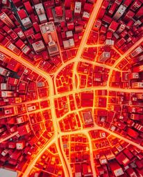 An extreme macro close-up reveals a stunning abstract city map composed of warm, golden-hour-lit geometric shapes.  The top-d