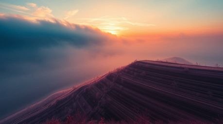 Experience the surreal beauty of fog-covered hills bathed in the warm glow of the setting sun, captured in striking infrared 