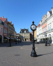 Capture the surreal stillness of an empty town square where time seems to stand still with ticking clocks and an absence of p