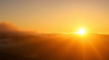 Experience the radiant and luxurious feel of warm golden light breaking through fog-covered hills. This artwork features crea